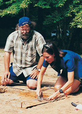 Photograph of man and woman excavating a square