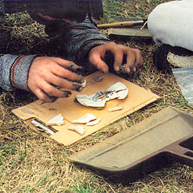 Photograph of youth piecing together a broken plate